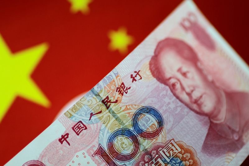 © Reuters. FILE PHOTO: A China yuan note is seen in this illustration photo May 31, 2017.     REUTERS/Thomas White/Illustration/File Photo