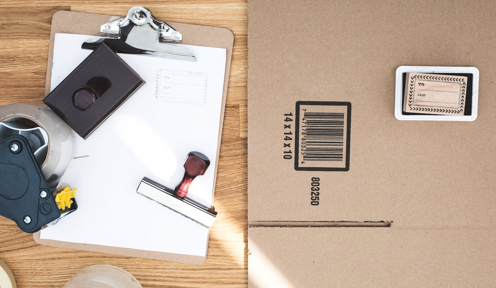 A flatlay of different shipping supplies, like a box and clipboard