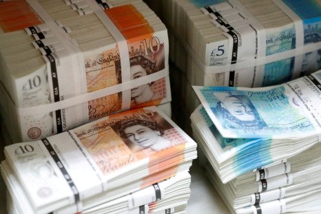 Wads of British Pound Sterling banknotes are stacked in piles at the Money Service Austria company's headquarters in Vienna