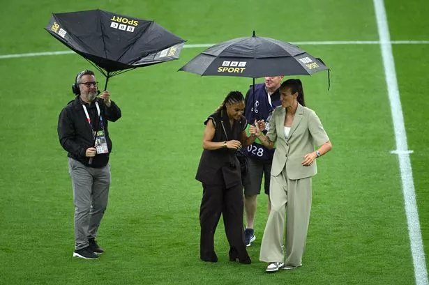 BASEL, SWITZERLAND - JULY 27: Former England football players and current BBC Sport pundits Alex Scott and Jill Scott take shelter under a umbrella prior to the UEFA Women's EURO 2025 Final match between England and Spain at St. Jakob-Park on July 27, 2025 in Basel, Switzerland. (Photo by Matthias Hangst/Getty Images)