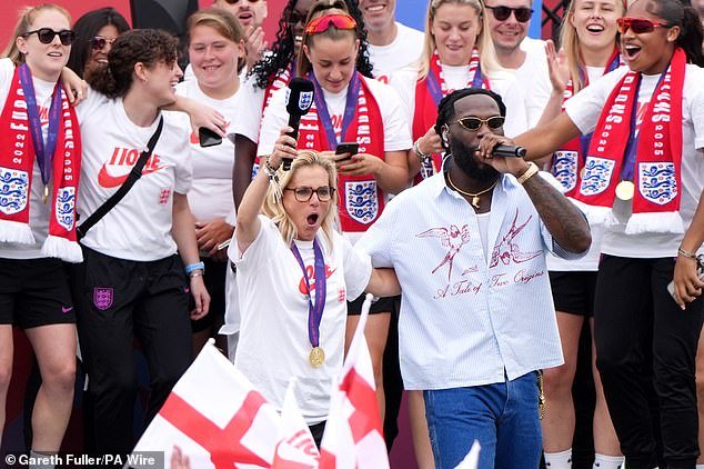 Sarina Wiegman on stage with Burna Boy, who she has described as her 'favourite' music artist