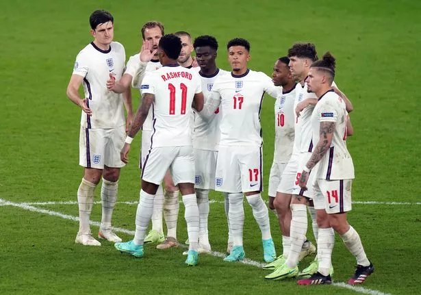 England's Marcus Rashford stands dejected with team mates after missing from the penalty spot during the penalty shoot out following  the UEFA Euro 2020 Final at Wembley Stadium