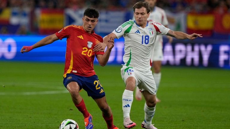 Spain's Pedri, left, is challenged by Italy's Nicolo Barella